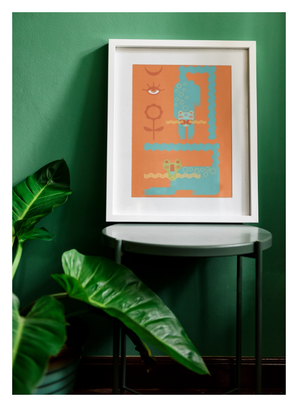 magical-snowcats-fine-art-print-party-mates-mystical-animal-wall-art-gail-evenden-framed-art-work-on-a-stool-leaning-on-green-wall-with-plants-next-to-it